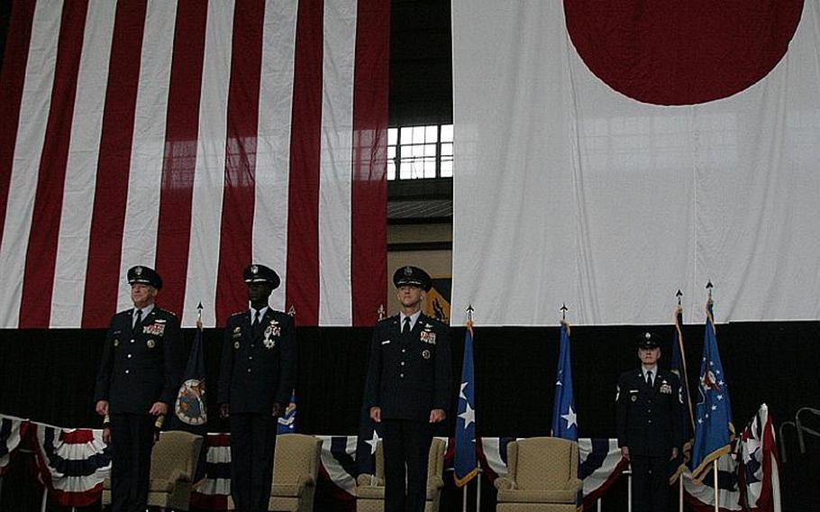 (Left to right) Gen. Gary North, commander of Pacific Air Forces, Lt. Gen. Edward Rice, outgoing U.S. Forces Japan commander, and Lt. Gen. Burton Field, incoming USFJ commander, take the state during a change of command ceremony Monday at Yokota Air Base. Field also took command of 5th Air Force, which Rice also led during his tenure with USFJ.