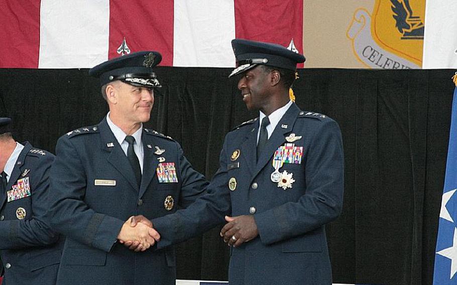 Incoming U.S. Forces Japan commander Lt. Gen. Burton Field, left, shakes hands with outgoing commander Lt. Gen. Edward Rice during a change of command ceremony Monday at Yokota Air Base.