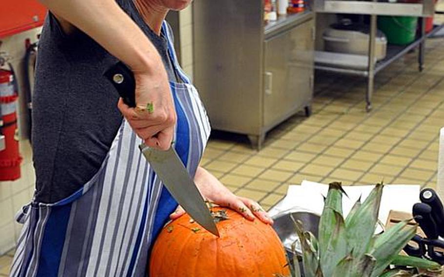Janeen Alley cuts into the secret ingredient 'fresh pumpkin' Wednesday during the Iron Chef competition at Misawa Air Base, Japan.