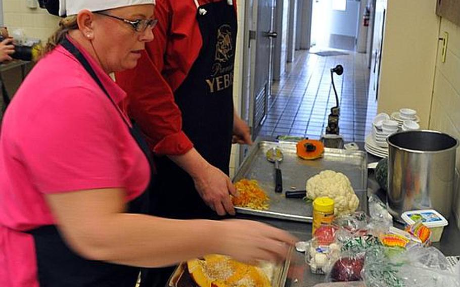 Erin Robinson and her sous chef James Maley start working on their four-course meal in the Iron Chef competition Wednesday at Misawa Air Base, Japan. Robinson, who won the contest last year, took it again Wednesday with Maley.