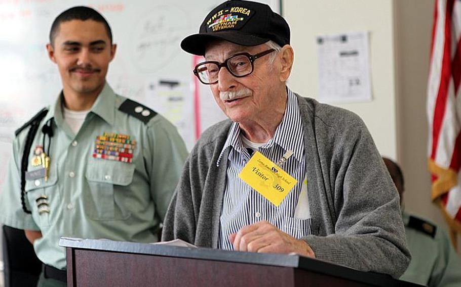 Mike Jurkoic, a retired World War II veteran, shares stories from his Army career with students at Zama American High School on Tuesday.
