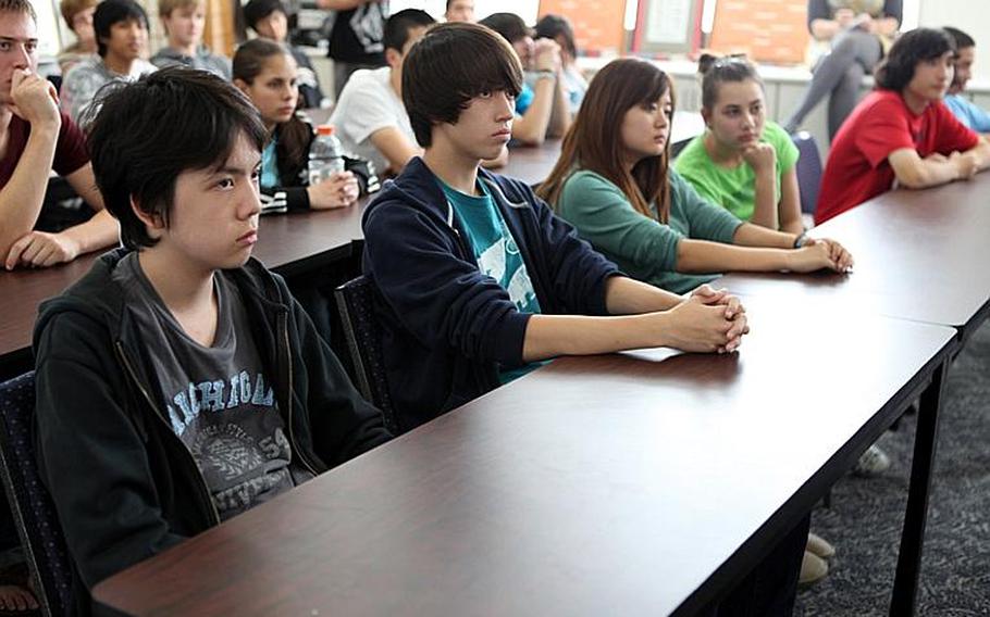 Students at Zama American High School listen Tuesday as World War II veteran Mike Jurkoic talks about meeting Gen. Douglas MacArthur. Jurkoic was guest speaker at a Veterans Day event at the high school.