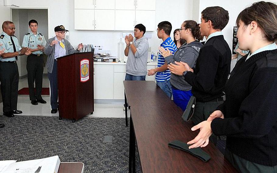 Students at Zama American High School applaud World War II veteran Mike Jurkoic, who visited the school Tuesday as guest speaker for a Veterans Day event.