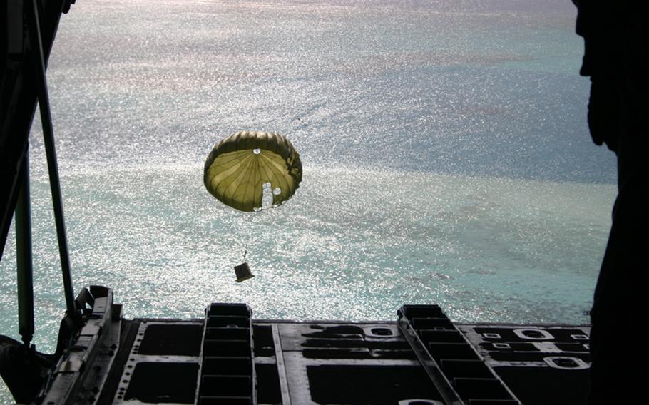 A box full of gifts and supplies makes its way to the water off Elato Island in Yap State in the Federated States of Micronesia. The box was parachuted as part of the 2005 Christmas Drop out of Andersen Air Force Base, Guam, from a C-130 transport plane crewed by members of the 36th Airlift Squadron of the 374th Airlift Wing based in Yokota Air Base, Japan. Boats are positioned below to retrieve the box.