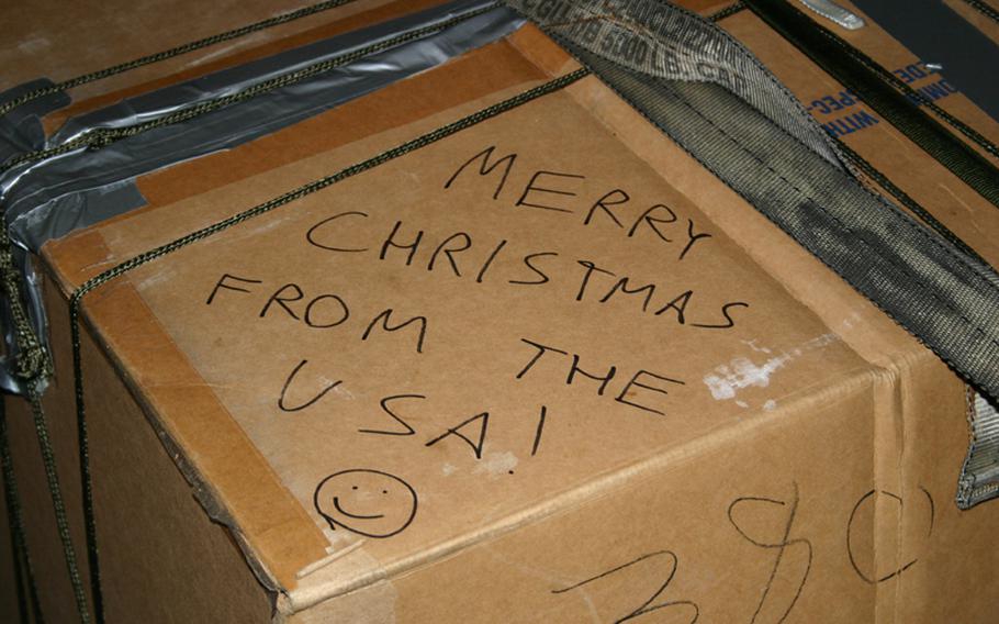 One of the 55 boxes packed for the 2005 Christmas Drop bears a message written by one of dozens of volunteers on Andersen Air Force Base, Guam who packed the boxes to be dropped to residents of remote Micronesian islands. The box was parachuted from one of three C-130 transport planes crewed by members of the 36th Airlift Squadron of the 374th Airlift Wing based at Yokota Air Base, Japan.