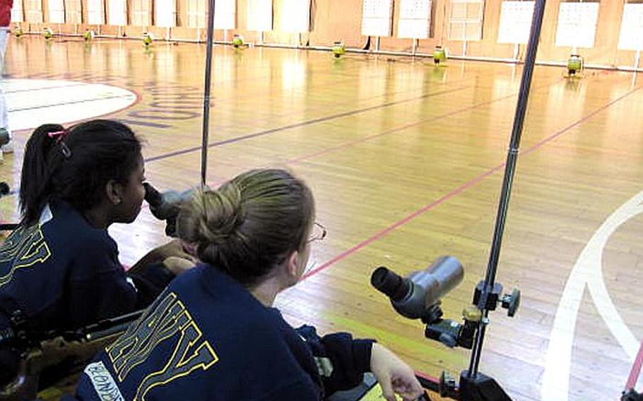 Two cadets prep themselves before firing their air rifles as cadets from throughout the Pacific competed in the first Far East DODEA Pacific JROTC Marksmanship Championships at E.J. King High School on Sasebo Naval Base, Japan.