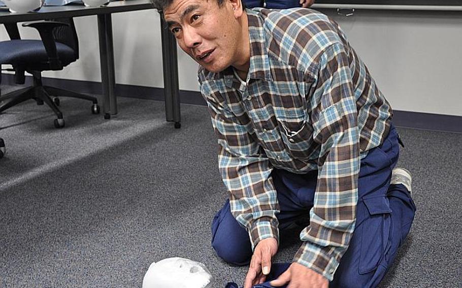 Masaru Baba, a Japanese employee with the 35th Civil Engineers Squadron at Misawa Air Base, Japan, uses a training dummy during a CPR class Tuesday. Members of the Japanese Red Cross Society came to the base to provide the training.