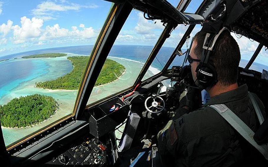 Capt. Phillip Newman, a C-130 Hercules pilot with 36th Airlift Squadron takes in the beauty of the Yap Islands during a flight for Operation Christmas Drop on Tuesday.