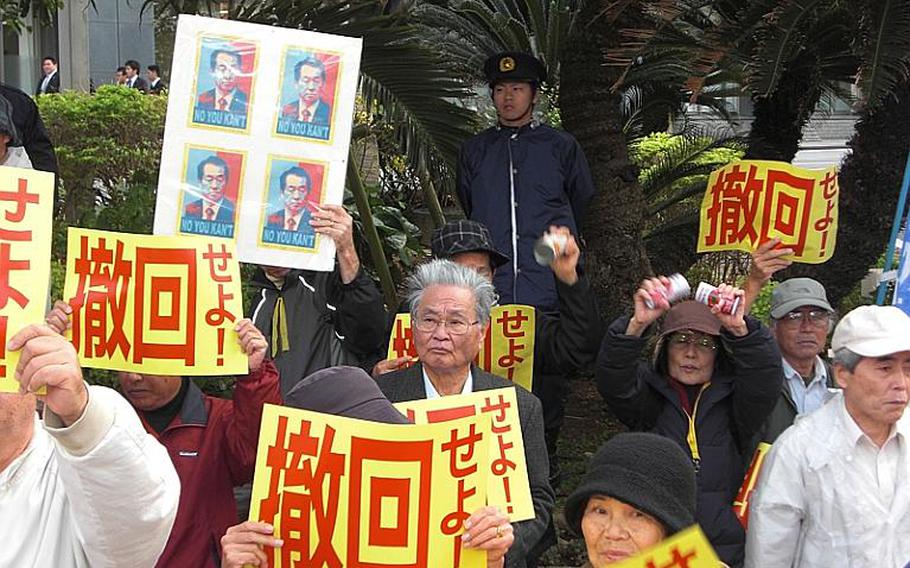 About 500 people gathered Friday in front of the Okinawa prefectural government office to protest Prime Minister Naoto Kan's visit to the island. Protesters want the Japanese government to withdraw from an accord to relocate Marine Corps Air Station Futenma operations to Camp Schwab with part of it extending into the Henoko waters.