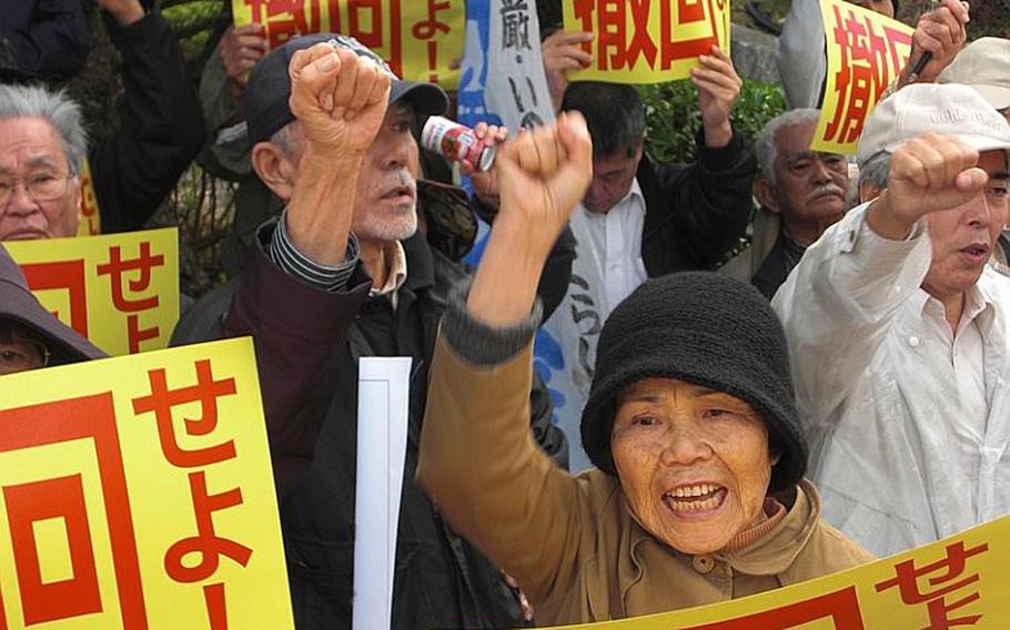 Toshiko Isagawa, 70, of Ginowan was among the protesters who gathered Friday in front of the Okinawa prefectural government office to protest Prime Minister Naoto Kan's visit to the island. 