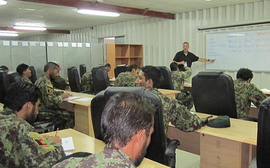 Thomas Wiglesworth, who normally teaches at Andersen Elementary School on Guam, instructs a class of Afghan security forces in Kandahar, Afghanistan, during a September class.