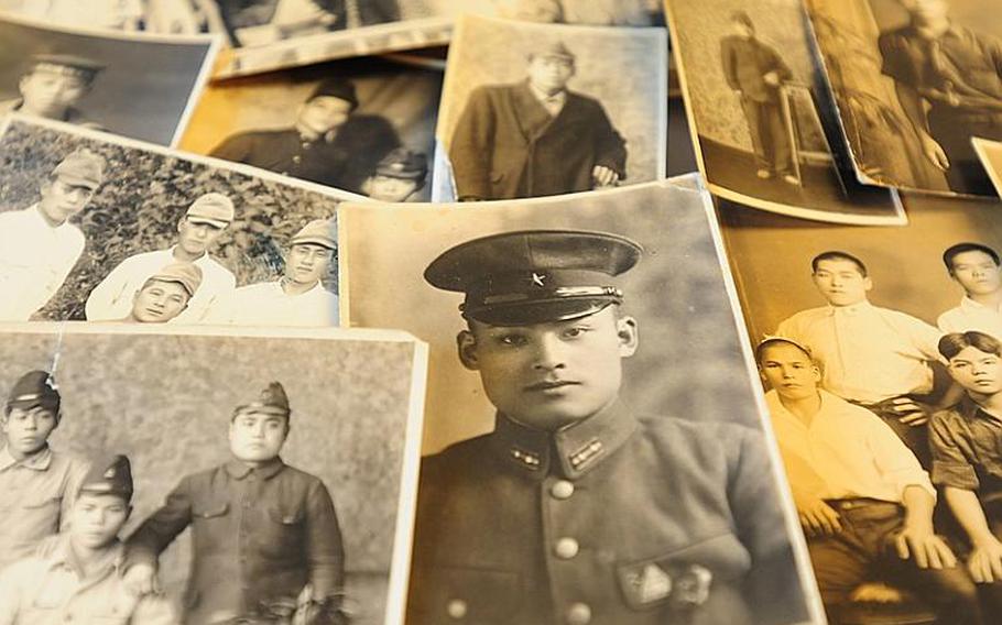 Some of the many photos in a wallet that Durl Gibbs took from a deceased Japanese soldier while fighting on Okinawa during World War II. Gibbs returned to Okinawa to return the wallet and photos to the soldier's relatives.