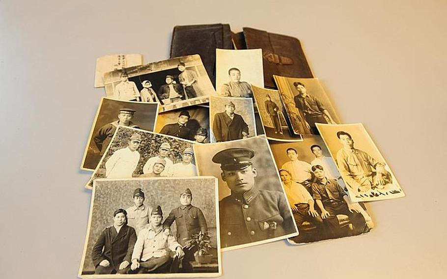 Some of the many photos in a wallet that Durl Gibbs took from a deceased Japanese soldier while fighting on Okinawa during World War II. Gibbs returned to Okinawa to return the wallet and photos to the soldier's relatives.