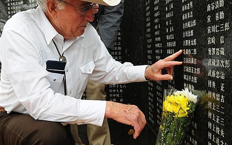 Durel Gibbs, left, places his finger next to the name of Japanese army Sgt. Keijiro Hojo. Gibbs and his son Wes, right, flew from Montana to return a wallet that Durl Gibbs took from Hojo's body during World War II.