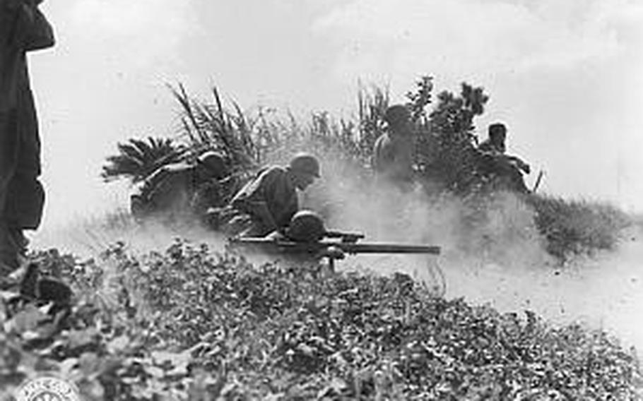 The crew of an M1917A1 heavy water-cooled machine gun secures a defensive line on Okinawa. The gun, including tripod and water, weighed 92 pounds but could fire 125 rounds per minute. Eight such weapons were in each battalion's heavy weapons company.