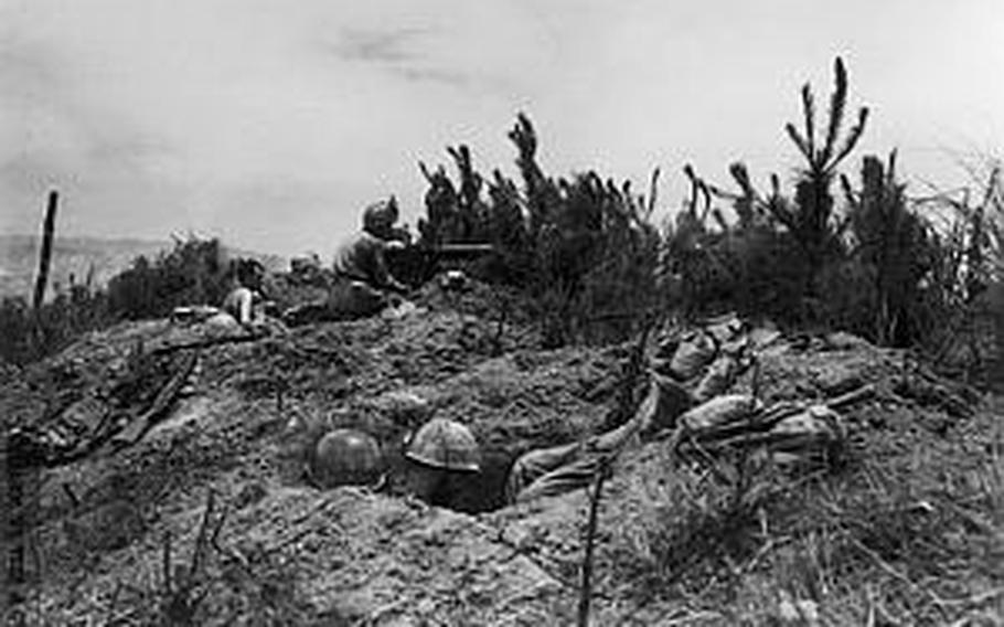 Army Pvt. Durel Gibbs was in one of the foxholes seen in this photo when his buddy defeated a Japanese imperial soldier after a hand-to-hand combat. A wallet Gibbs took from a pocket of the solider contains a dozen of photographs and an envelope containing hair and clipped nails, which is believed to have served as identification of the bearer during wartime. The family of the slain solider is yet to be located while his hometown is believed to be in Iwate prefecture, in the northern part of Japan.