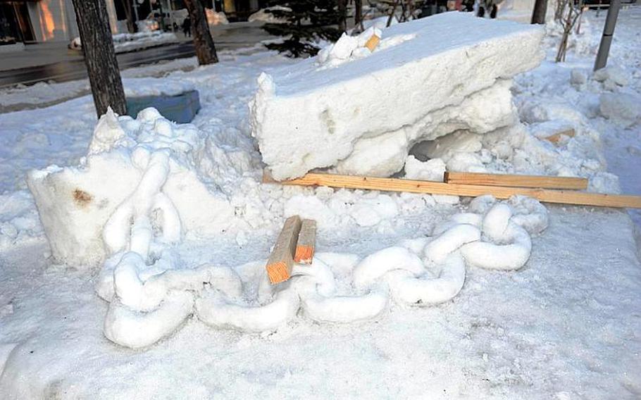 This was all that remained of a sculpture of a ship's anchor after it collapsed Thursday at the Sapporo Snow Festival. The U.S. sailors who built the sculpture were scrambling Friday to rebuild it.