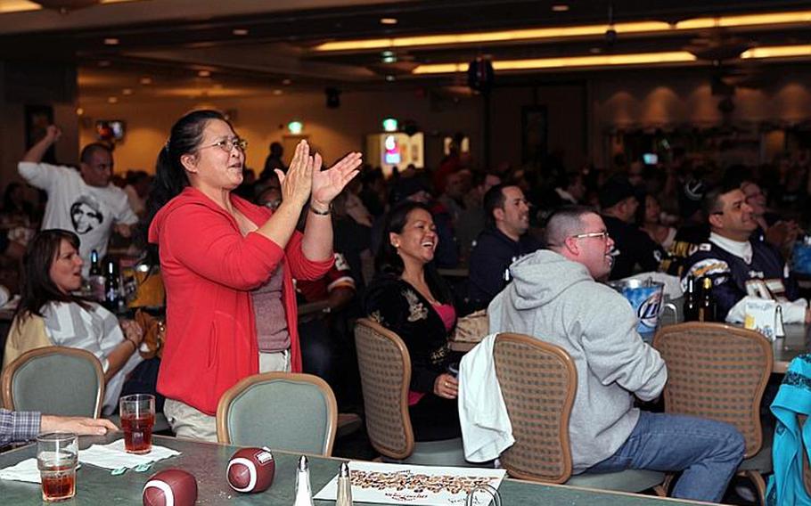 Packer fans at Yokota Air Base's Enlisted Club cheer on their team in the final seconds of their defensive push to win the game.