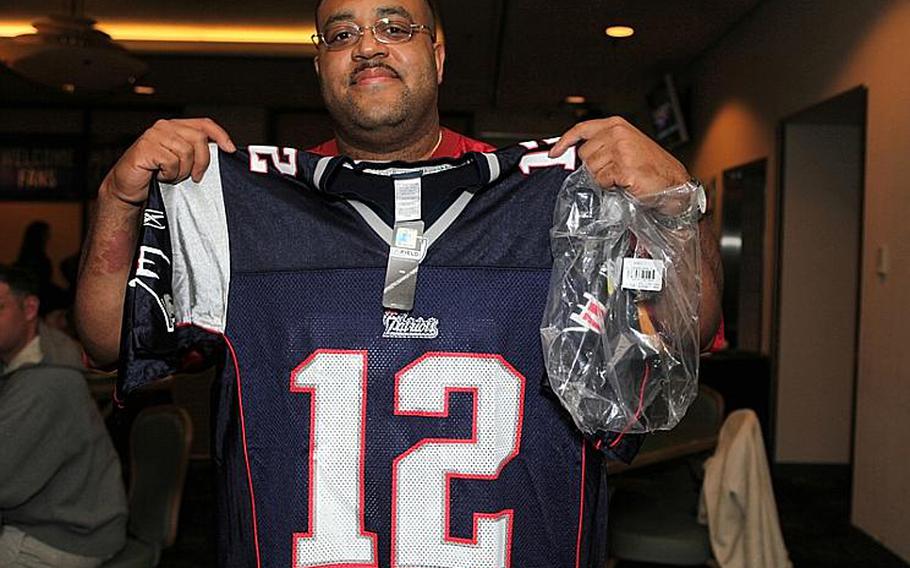 Master Sgt. Shawn Cheek, U.S. Forces Japan, shows off the New England Patriots' Tom Brady jersey, which he won during Monday's viewing of the Super Bowl at the Yokota Air Base Enlisted Club.