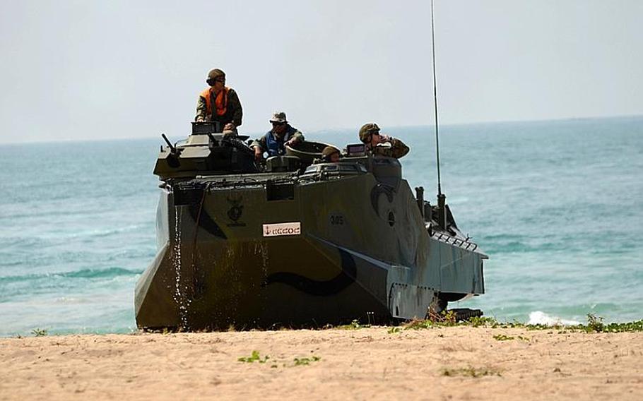 Royal Thail Marines, along with infantry Marines with the Battalion Landing Team, 2nd Battalion, 5th Marine Regiment, 31st Marine Expeditionary Unit, 3rd Marine Expeditionary Brigade Forward (FWD)drive an amphibious assault vehicle onto the beachhead in a mock amphibious assault raid Thursday during Exercise Cobra Gold 2011.