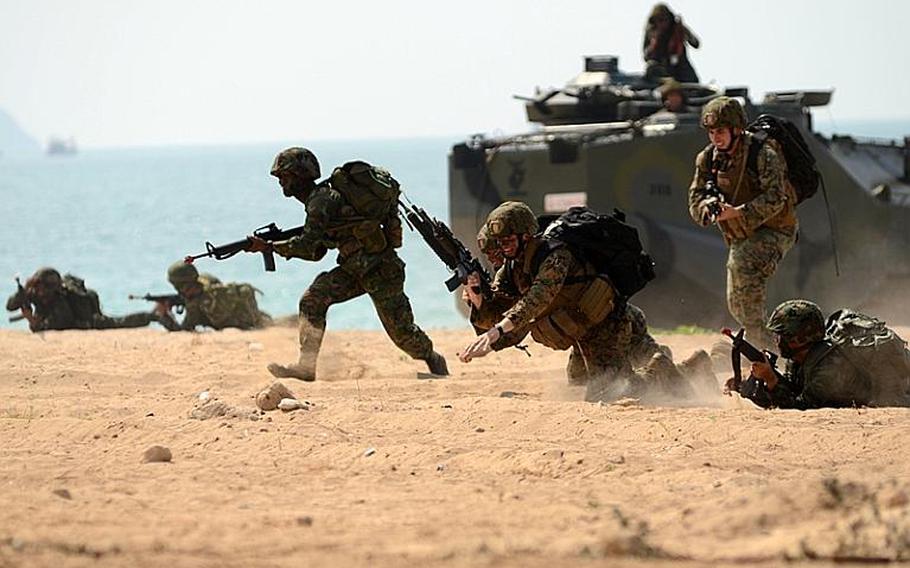 Royal Thai Marines, along with infantry Marines with the Battalion Landing Team, 2nd Battalion, 5th Marine Regiment, 31st Marine Expeditionary Unit, 3rd Marine Expeditionary Brigade Forward (FWD) assault the beachhead in Hat Yao, Thailand, in a mock amphibious assault raid Thursday during Exercise Cobra Gold 2011.