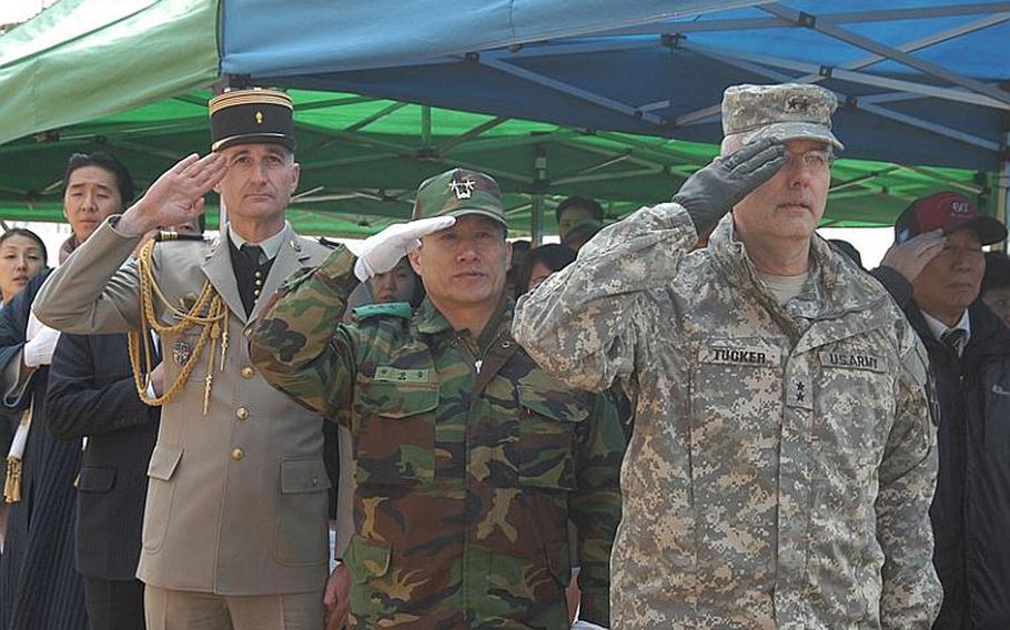 From left, Col. Eric Jouin, French Embassy defense attache; South Korean Maj. Gen. Na Sang-woong and U.S. Army Maj. Gen. Michael Tucker, commander of the 2nd Infantry Division, salute during the playing of the three countries' national anthems at ceremonies Tuesday marking the 60th anniversary of the Battle of Chipyong-ni. The 1951 battle is considered the turning point in the Korean War.