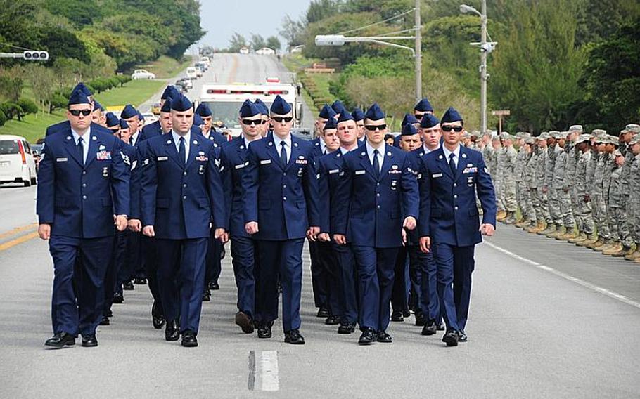 Airmen march down Douglas Blvd. on Kadena Air Base, Okinawa, during a memorial procession Wednesday for Airman 1st Class Derek Kozorosky, who was killed Friday in a vehicle accident on base.