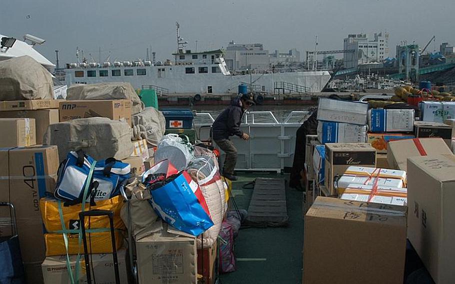 Luggage and other goods fill up the deck of a ferry bound for South Korea's Yeonpyeong Island Thursday. More than 100 island residents boarded the ferry in Incheon for their return from the mainland, where most island residents have stayed since North Korea shelled their fishing village on Nov. 23.