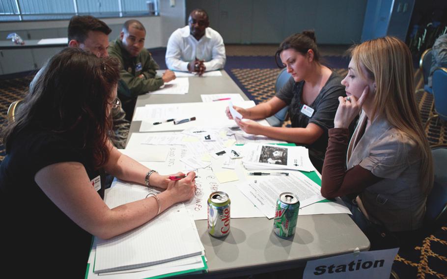 Military and civilian volunteers brainstorm on how to deal with a mass casualty situation during the disaster training course Thursday at Yokota Air Base's Taiyo Community Center.