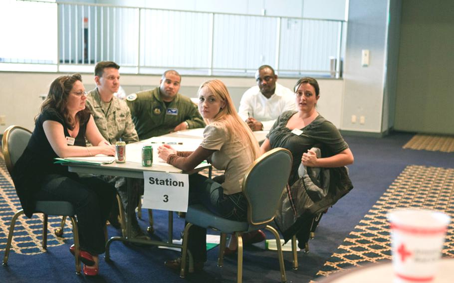 Military and civilian volunteers share ideas on how to deal with mass casualty situations during the disaster training course Thursday at Taiyo Community Center on Yokota Air Base, Japan.