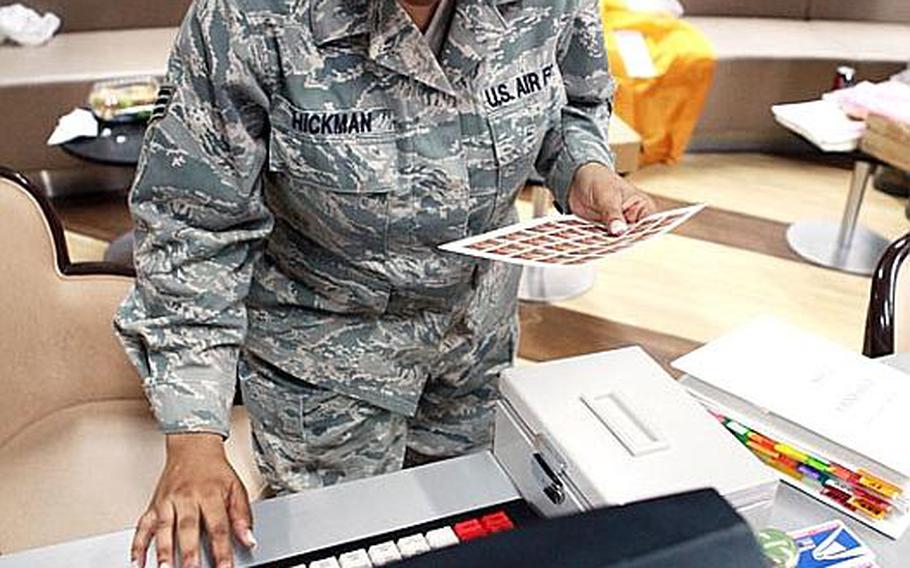 Senior Airman Shyrhonda Hickman, a postal clerk with the 374th Communications Squadron tests out Yokota's mail Contigency Kit and tests its capabilities of setting up a temporary post office capable of processing overseas customers mail at the Yujo Community Center, Tuesday.