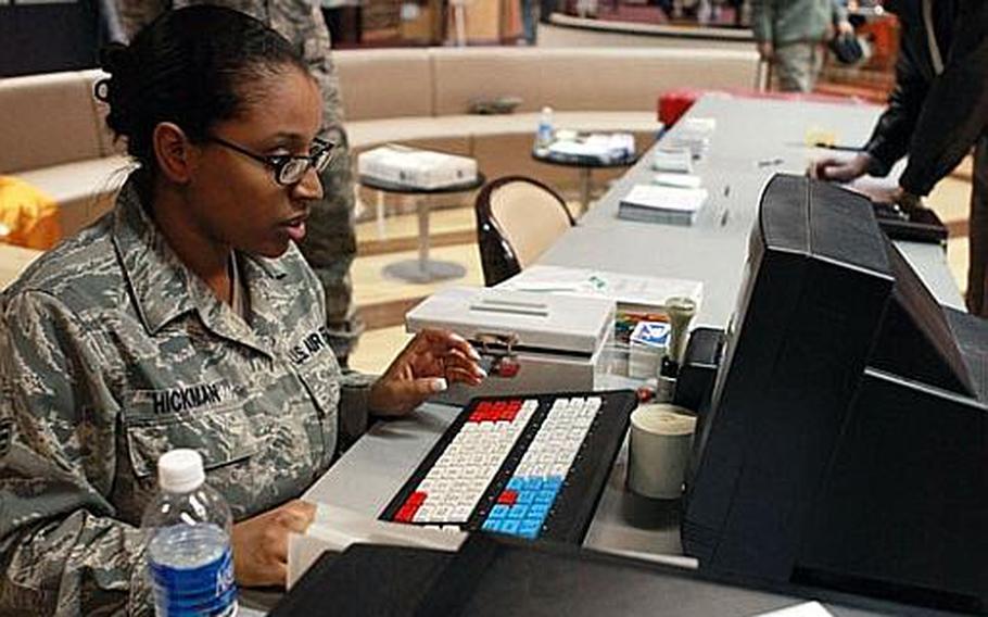 Senior Airman Shyrhonda Hickman, left, a postal clerk with the 374th Communications Squadron, tests out Yokota's mail Contigency Kit and tests its capabilities of setting up a temporary post office capable of processing overseas customers mail at the Yujo Community Center on Tuesday.