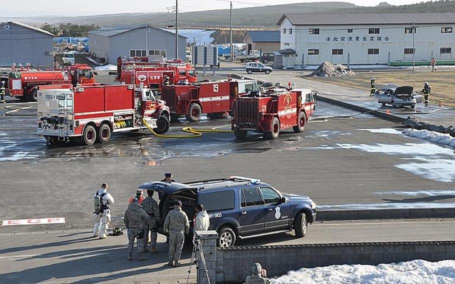 Misawa City and Misawa Air Base fire trucks crowded into the city port Wednesday for a joint training exercise that allowed Japanese and American officials to fine-tune their response to an off-base incident involving an American aircraft.