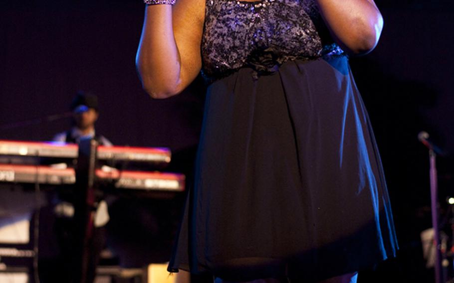 A background vocalist for Grammy Award-winning artist Macy Gray sings during a free concert at Yokosuka Navy Base, Japan, on  Feb. 23.