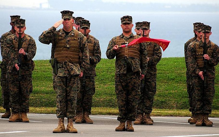 Marines render salutes during the 3rd Marine Division change of command ceremony Tuesday. Maj. Gen. James B. Laster relinquished command of 3rd Marine Division to Brig. Gen. Mark A. Brilakis.