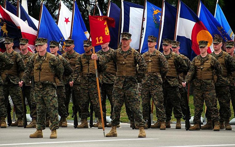 Marines stand at parade rest during the 3rd Marine Division change of command ceremony Tuesday. Maj. Gen. James B. Laster relinquished command of 3rd Marine Division to Brig. Gen. Mark A. Brilakis aboard Camp Courtney on Okinawa.