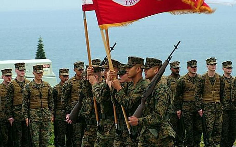 The color guard passes the troops in formation during the change of command for 3rd Marine Division Tuesday. Maj. Gen. James B. Laster relinquished command of 3rd Marine Division to Brig. Gen. Mark A. Brilakis aboard Camp Courtney on Okinawa.