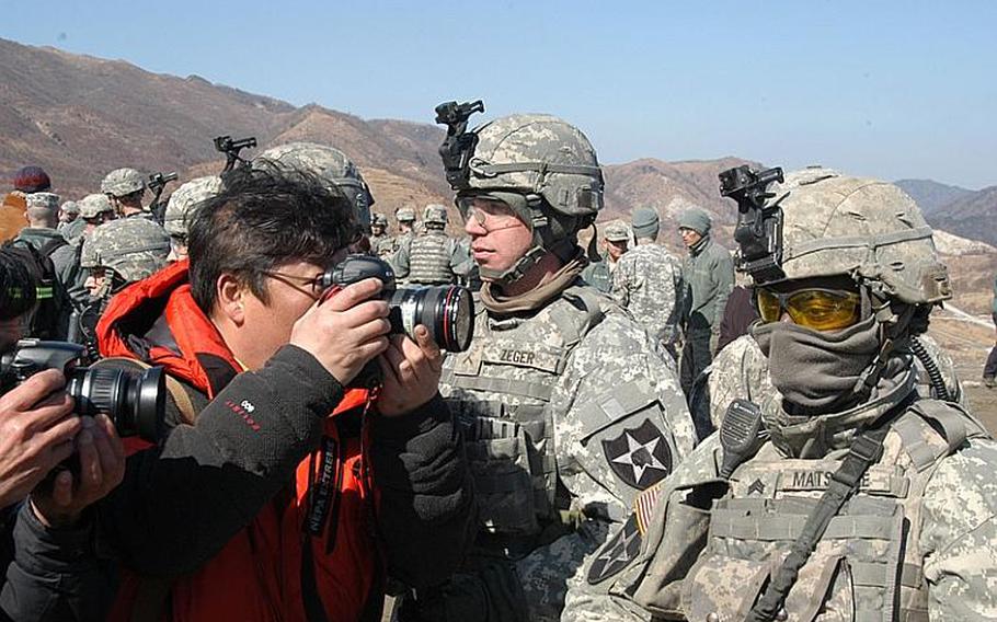 A photographer gets up close and personal with a soldier taking part Monday in a live-fire drill near the Demilitarized Zone in South Korea. About 100 media representatives were on hand as four U.S.-based Strykers were put through their paces during a 90-minute exercise.