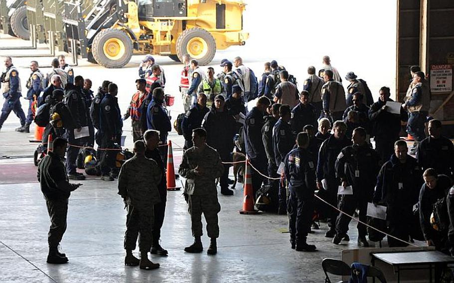 About 150 of America's top search-and-rescue specialists arrive at Misawa Air Base, Japan, on Sunday en route to rescue efforts along Japan's battered coast.