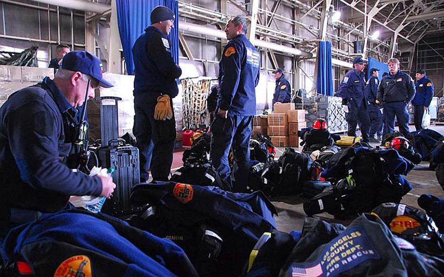 Members of the Los Angeles Fire Department's California Task Force 2 search-and-rescue team prepare Monday to depart for a devastated fishing village in Iwate prefecture.