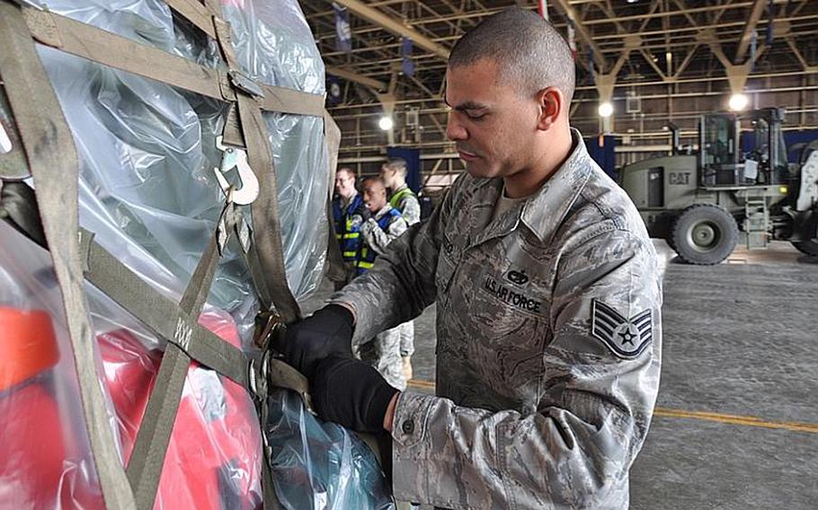 Staff Sgt. Paul Herzog, of Misawa's 35th Logistics Readiness Squadron, secures rescue gear for transport to a coastal village devastated by Friday's earthquake.