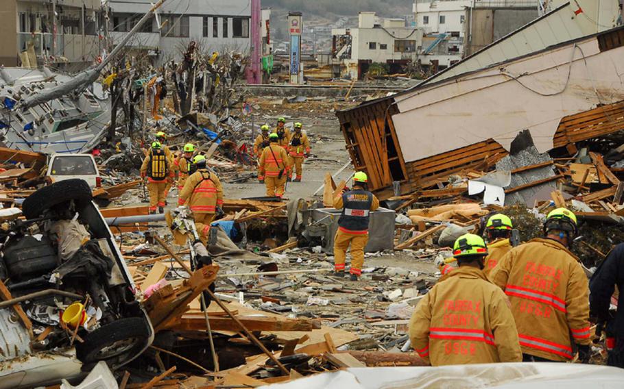 A Fairfax County search-and-rescue unit walks into the disaster zone at Ofunato, Japan, as it begins rescue efforts Tuesday.