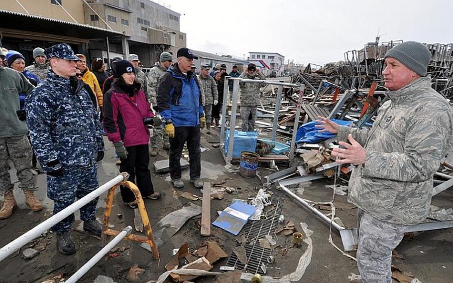 Chief Master Sgt. Robert Hipple, of the 35th Fighter Wing at Misawa Air Base, Japan, briefs volunteers who traveled to Hachinohe city to help clean up the port area, damaged when a 9-foot tsunami hit March 11.
