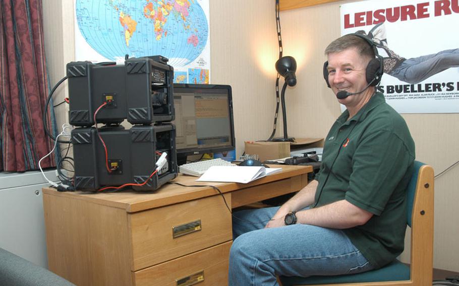 U.S. Army Maj. Scott Hedberg talks on the ham radio he has set up in his barracks room at Camp Red Cloud in South Korea.