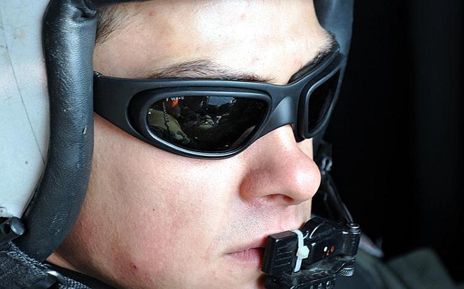 Petty Officer 3rd Class Caleb Benedict looks out the side door of a Seahawk helicopter into the tsunami devastation left scattered along Japan's northeastern coast during a humanitarian relief supply mission on Tuesday. 'It feels really good to be able to help these people,'he said. 'I know that if there's anything we could possibly do to help them, then we're gonna do it.'