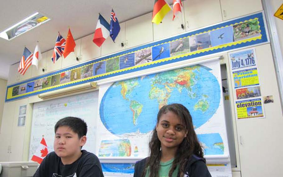 Jerome Nicdao and Moira Offord, both 13, talk about remaining in Yokosuka Middle School on Wednesday even as their peers leave Japan with their parents. More than 4,000 family members have signed up to leave Japan as part of a military-assisted "voluntary departure" announced Thursday. Others evacuated on their own, soon after the March 11 earthquake.