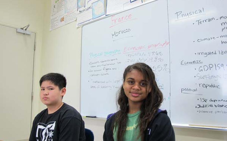 Jerome Nicdao and Moira Offord, both 13, talk about remaining in Yokosuka Middle School on Wednesday even as their peers leave Japan with their parents. More than 4,000 family members have signed up to leave Japan as part of a military-assisted "voluntary departure" announced Thursday. Others evacuated on their own, soon after the March 11 earthquake.