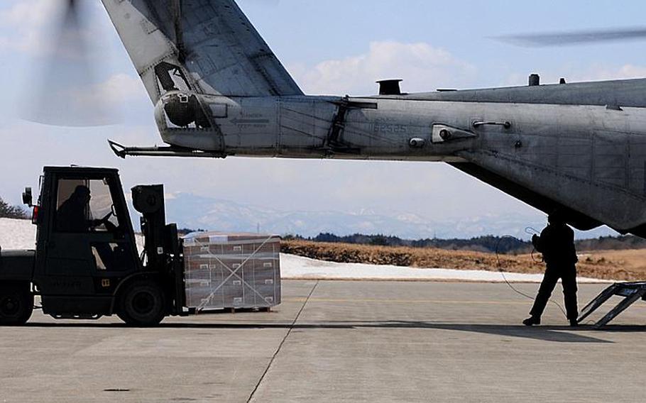 Servicemembers load humanitarian assistance and disaster relief supplies onto a CH-53E Sea Stallion helicopter assigned to Marine Medium Helicopter Squadron 262 on Tuesday.