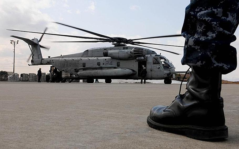 Servicemembers load humanitarian assistance and disaster relief supplies Tuesday onto a CH-53E Sea Stallion helicopter assigned to Marine Medium Helicopter Squadron 262 launched from the amphibious assault ship USS Essex.