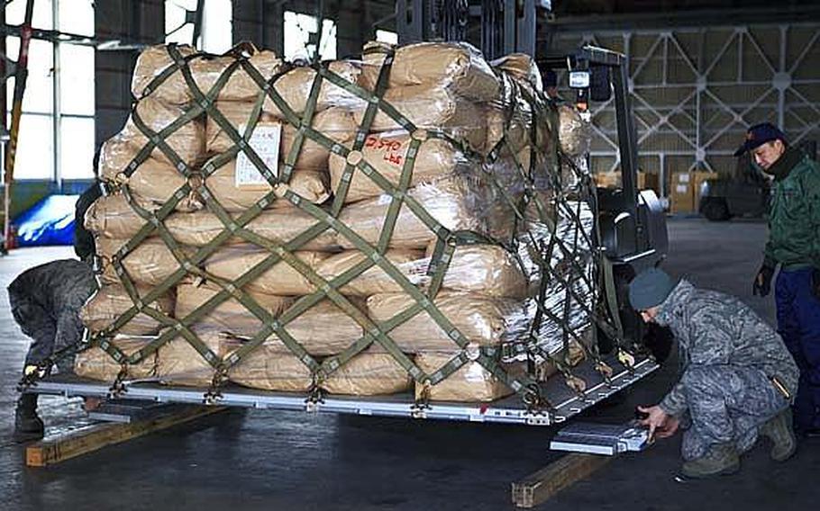 Senior Airman Bradley Collier, of Yokota Air Base's 374th Logistics Readiness Squadron, weighs a pallet of food and supplies headed to Matsushima Air Base. Yokota was the headquarters for Operation Tomodachi, the U.S. military's humanitarian assistance efforts in northeastern Japan.